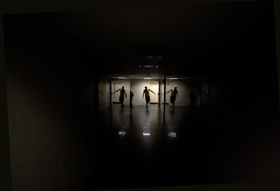 In this Dec. 4, 2018 photo, a dancer warms up in preparation for the contemporary dance production Ubuntu, at the Teresa Carreno Theater in Caracas, Venezuela. Students' love for dance has helped them overcome the numerous obstacles faced by disabled people in Venezuela, where public transport is still mostly inaccessible to people on wheelchairs and ramps on sidewalks and public buildings are few and far between. (AP Photo/Fernando Llano)