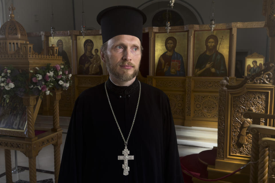 The Rev. Ioann Koval stands inside an old Orthodox church in Antalya, Turkey, Sunday, July 16, 2023. Koval started serving in this church after the Russian Orthodox Church leadership decided to defrock him following his prayer for peace in Ukraine. Koval, who used to serve in a church in Moscow, appealed the decision to Ecumenical Patriarch Bartholomew of Constantinople, and the Constantinople ruled to restore his holy rank, allowing him to serve in one of its churches. (AP Photo/Kostya Manenkov)