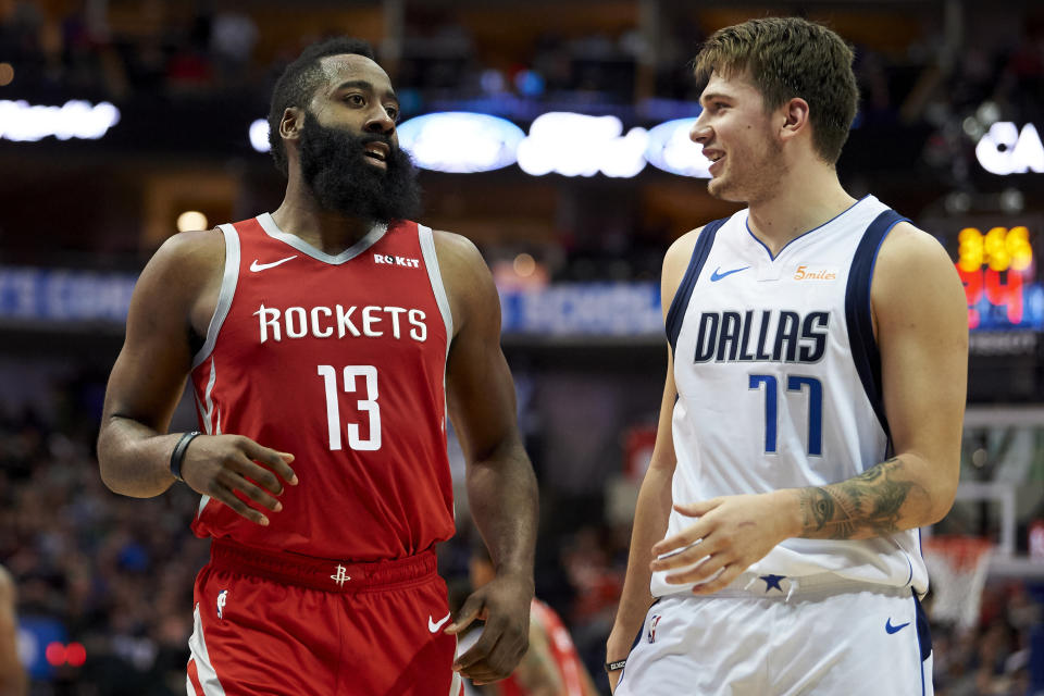 Houston Rockets guard James Harden (13) and Dallas Mavericks forward Luka Doncic (77) talk during the second half of an NBA basketball game, Saturday, Dec. 8, 2018, in Dallas. (AP Photo/Cooper Neill)