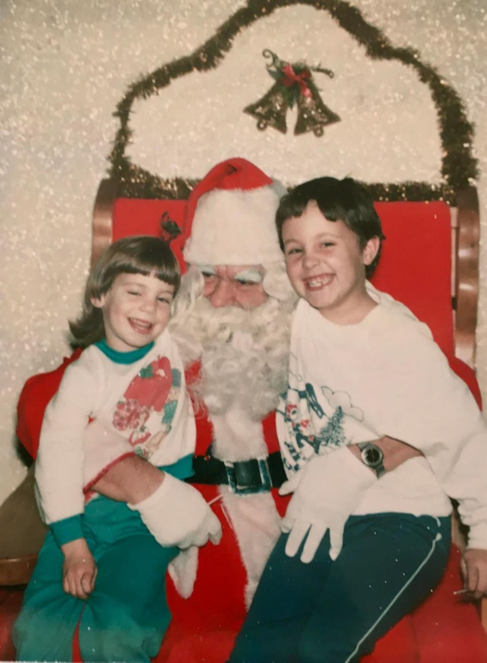 Sisters Melinda and Sonya sit on Santa's lap in the early 1980s. Mel Campbell started giving his daughters Life Savers books in their stockings when Sonya, the older daughter, was 2.