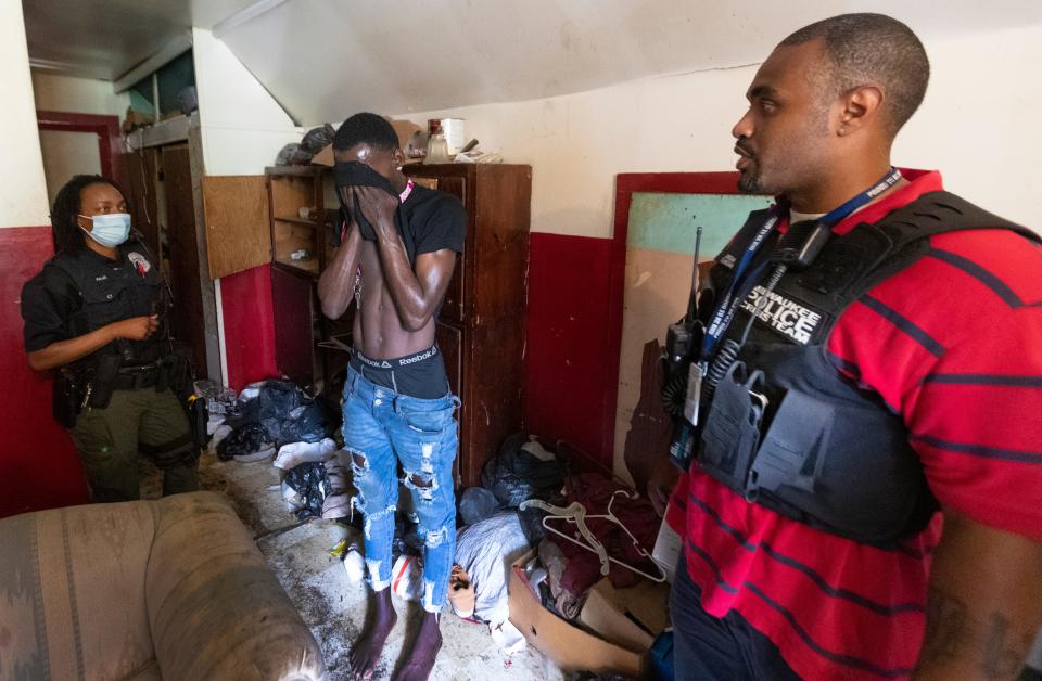 Milwaukee Police Officer Chandra Fuller, left, and clinician Jordan Hoeft follow-up with a young man with mental health issues in the sweltering heat of an unventilated second floor of a house on the north side of Milwaukee. Hoeft, a counselor from the Milwaukee County Behavioral Health Division, and Fuller make up a Crisis Assessment Response Team (CART). The team is an alternative response to 911 calls involving mental health issues.