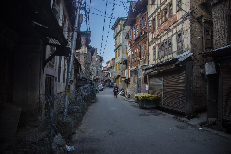 A Kashmiri man walks through a locality where many Kashmiri Hindu families used to live before the 1989 anti-India rebellion in Srinagar, Indian controlled Kashmir on Oct. 11, 2021. A spate of recent killings has rattled Indian-controlled Kashmir, with violence targeting local minority members and Indian civilians from outside the disputed region. The targeted killings have led to widespread unease, particularly among the region’s religious minority Hindus, most of whom fled Kashmir after an anti-India rebellion erupted in 1989. (AP Photo/Mukhtar Khan)