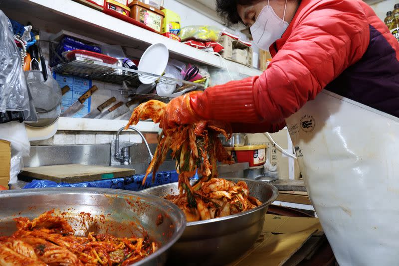 Choi Sun-hwa makes a traditional Korean side dish kimchi at her side dish store at a traditional market in Seoul