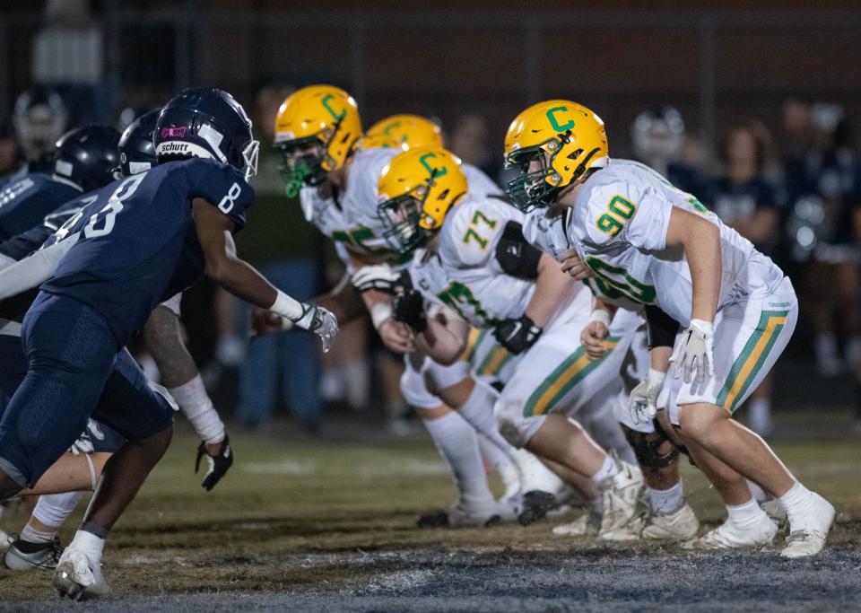 The Crusaders offensive line get set to engage the Braves defensive line during the Catholic vs Walton high school playoff football game at Walton HIgh School in DeFuniak Springs on Friday, Nov. 17, 2023.