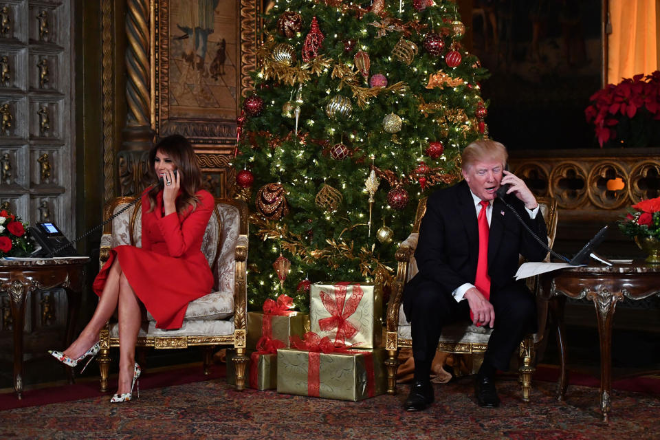 <p>DEC. 24, 2017 – President Donald J. Trump and the First Lady Melania Trump participate in NORAD Santa Tracker phone calls at the Mar-a-Lago resort in Palm Beach, Florida . (Photo: Nicholas Kamm/AFP/Getty Images) </p>