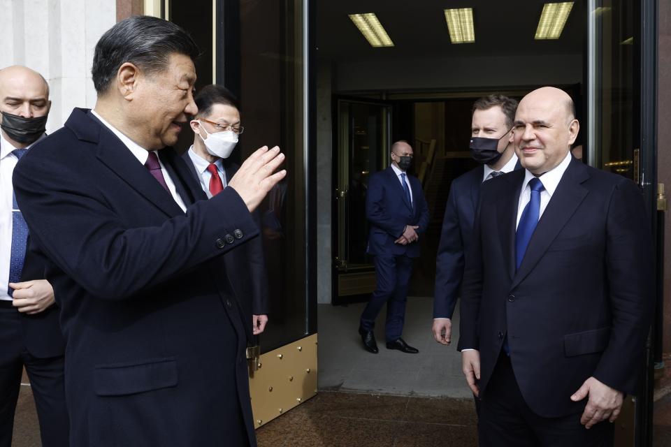 Chinese President Xi Jinping, left, waves to Russian Prime Minister Mikhail Mishustin as he leaves after their talks in Moscow, Russia, Tuesday, March 21, 2023. (Dmitry Astakhov, Sputnik, Government Pool Photo via AP)