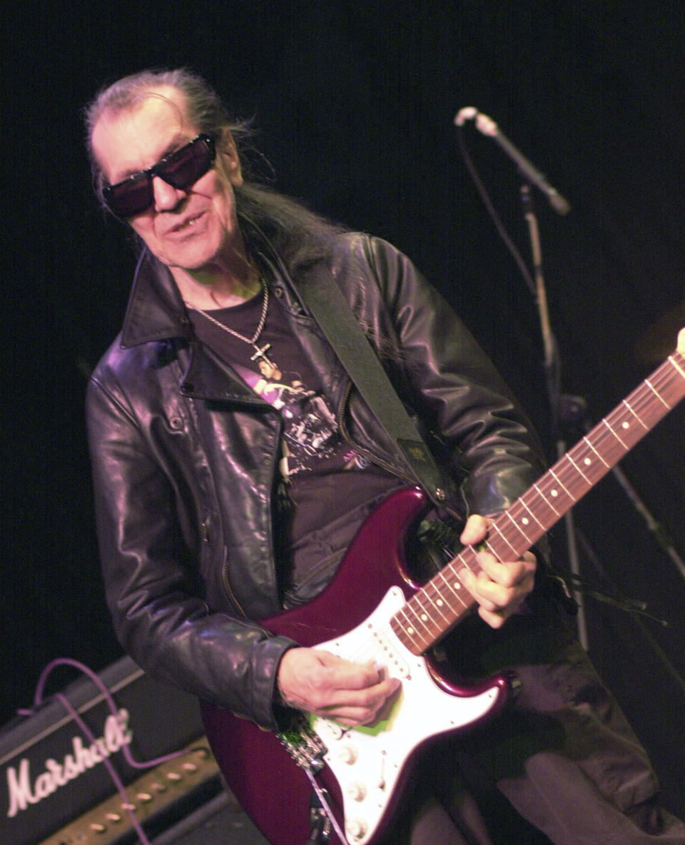 FILE - In this July 21, 2002 file photo, Link Wray, the 73-year-old Shawnee Indian and acclaimed pioneer of punk and heavy metal, performs at the Shim Sham Club in New Orleans. "RUMBLE: The Indians Who Rocked the World," a new PBS Independent Lens documentary set to air Monday, Jan 21, 2019, shows how Native Americans laid the foundations to rock, blues and jazz. (AP Photo/Cheryl Gerber, File)