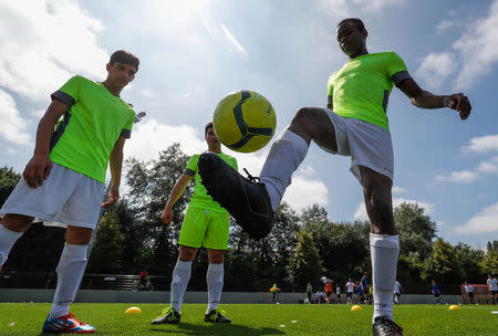 Asylum seekers take part in the soccer tournament "All on the pitch" organised by NGO's and Belgian Football Association at the occasion of the World Refugee Day, in Deurne, Belgium June 20, 2018. REUTERS/Yves Herman