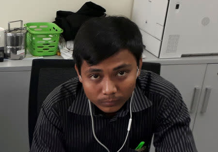 FILE PHOTO: Reuters journalist Kyaw Soe Oo, who is based in Myanmar, poses for a picture at the Reuters office in Yangon, Myanmar December 11, 2017. REUTERS/Antoni Slodkowski/File Photo