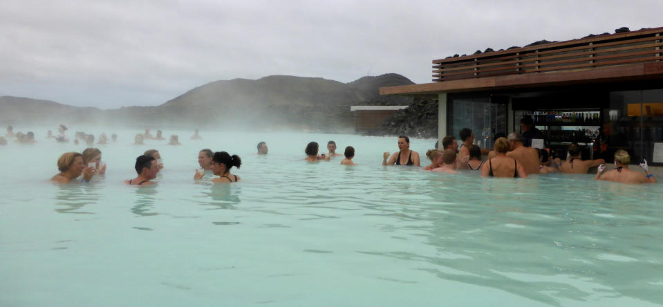 Visitors enjoy a drink in the Blue Lagoon geothermal spa in Grindavik, Iceland, May 25, 2016. REUTERS/Gwladys Fouche