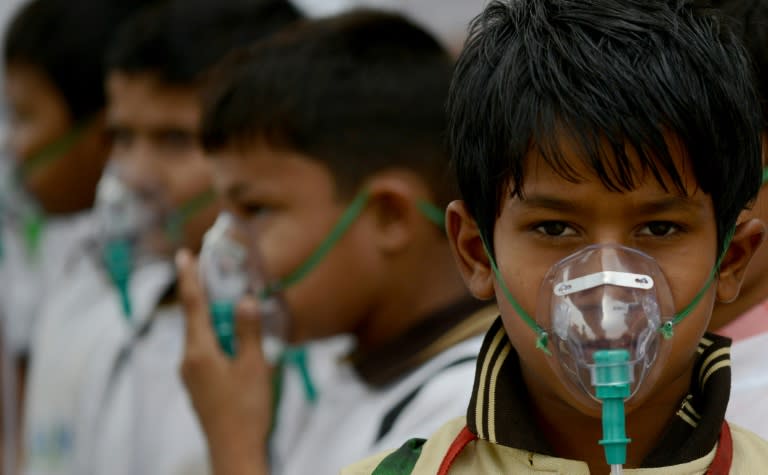 Indian schoolchildren wear facemasks to spread awareness of the problem of air pollution in New Delhi, after the World Health Organisation declared New Delhi the world's most polluted capital in 2014