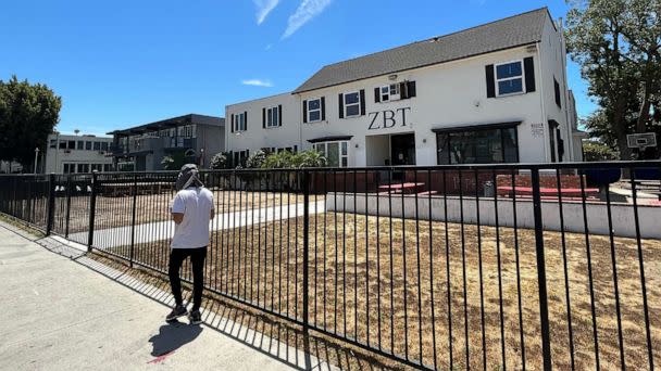 PHOTO: A man walks by the Zeta Beta Tau fraternity house on W 28th Street, 'Frat Row,' on Aug. 12, 2022, in Los Angeles. (Carolyn Cole/Los Angeles Times via Getty Images)