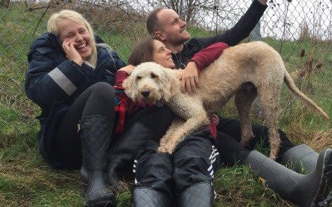 Cooper the Labradoodle was put on the wrong flight by WestJet staff, then lost at the airport. Owner Terri Pittman is centre - CBC