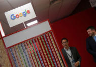 Attendees talk beside a Google digital workshop stand at the Labour Party Conference venue in Brighton, Britain, September 26, 2017. REUTERS/Toby Melville