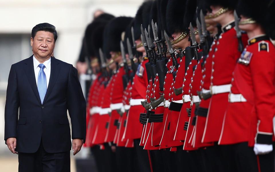 LONDON, ENGLAND - OCTOBER 20: China's President, Xi Jinping (L), accompanied by Prince Philip (behind, not pictured) reviews an honour guard on October 20, 2015 in London, England. The President of the People's Republic of China, Mr Xi Jinping and his wife, Madame Peng Liyuan, are paying a State Visit to the United Kingdom as guests of The Queen. They will stay at Buckingham Palace and undertake engagements in London and Manchester. The last state visit paid by a Chinese President to the UK was Hu Jintao in 2005. (Photo by Carl Court/Getty Images) - Carl Court/Getty Images