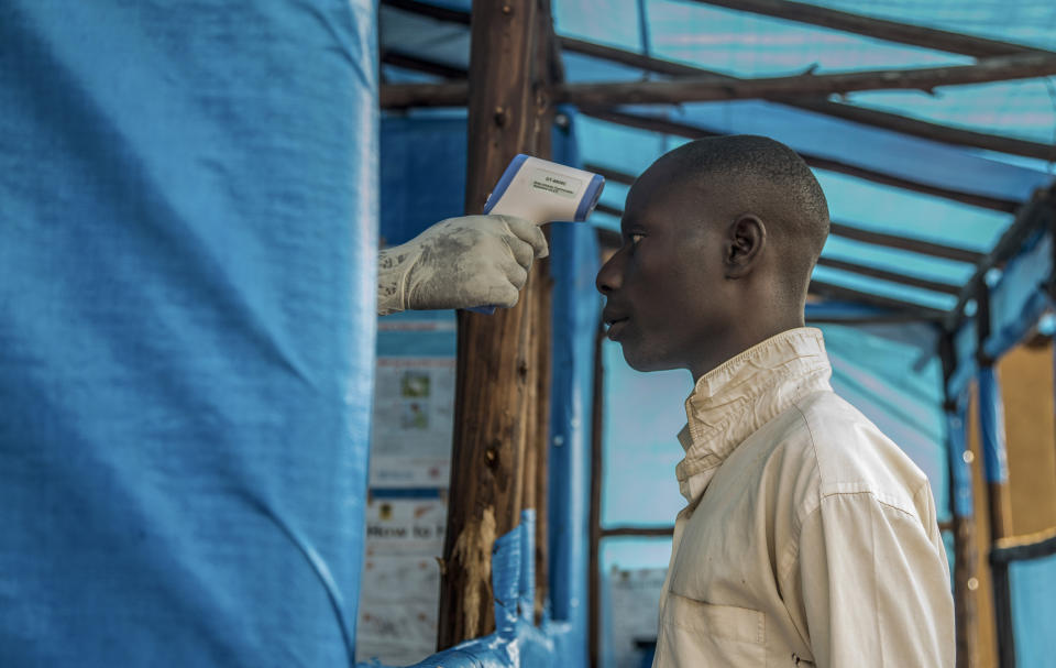 In this photo provided by the International Rescue Committee, a Congolese refugees is screened for Ebola symptoms at the IRC triage facility in the Kyaka II refugee settlement in Kyegegwa District in western Uganda, Thursday, June 13, 2019. The Congolese pastor who is thought to have caused the Ebola outbreak's spread into Uganda was unknown to health officials before he died of the disease, the World Health Organization's emergencies chief said Thursday, underlining the problems in tracking the virus. (Kellie Ryan/International Rescue Committee via AP)
