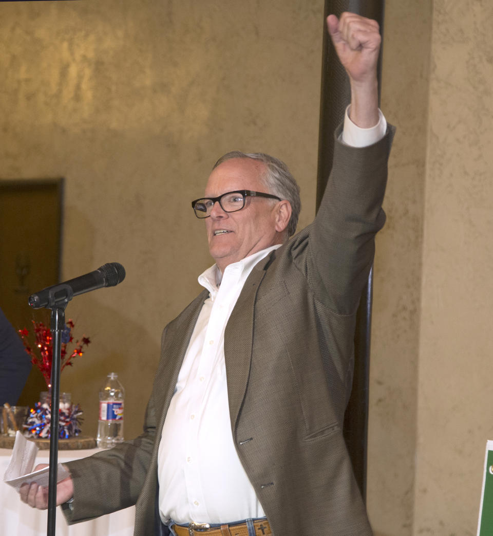 FILE - In this March 6, 2018 file photo, McLennan County District Attorney Barry Johnson raises his hand while thanking supporters during an election party, in Waco, Texas. Johnson said in a statement Tuesday, April 2, 2019, that all charges will be dropped in the 2015 shootout between rival biker gangs in Waco restaurant parking lot that left nine people dead and at least 20 injured. Johnson said any further effort to prosecute the case would be a "waste of time, effort and resources." (Rod Aydelotte/Waco Tribune Herald, via AP, File)