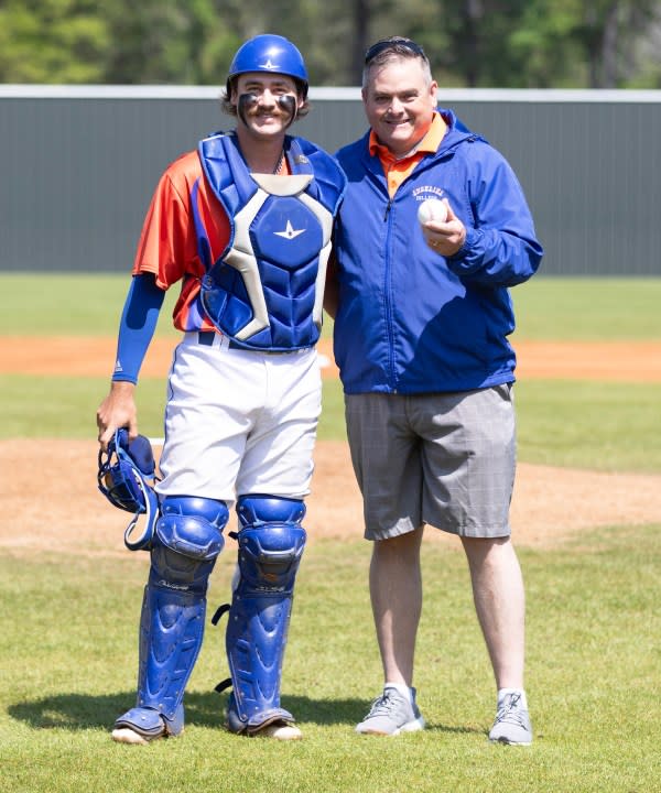 Steve Rayburn and catcher Jack Brinson after the first pitch.