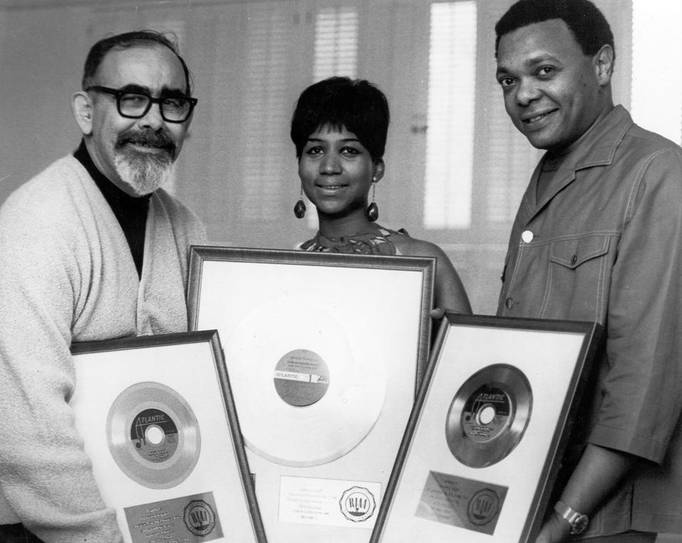 Jerry Wexler, Aretha Franklin, and her husband-manager, Ted White, pose with her platinum records in 1968.