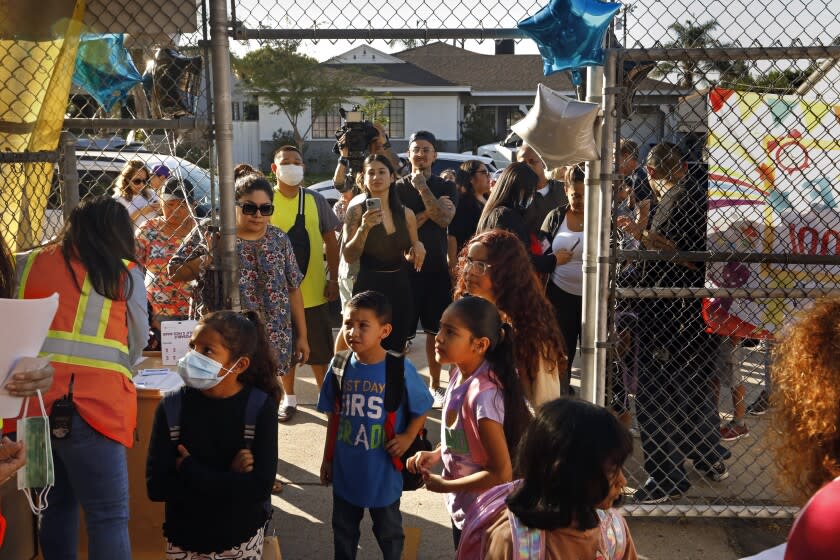 Los Angeles, Arleta, California-Aug. 15, 2022-Parents say goodbye and watch as their students enter Vena Avenue Elementary & Gifted/High Ability Magnet in Arleta, CA on the first day of classes Aug. 15, 2022. (Carolyn Cole / Los Angeles Times)