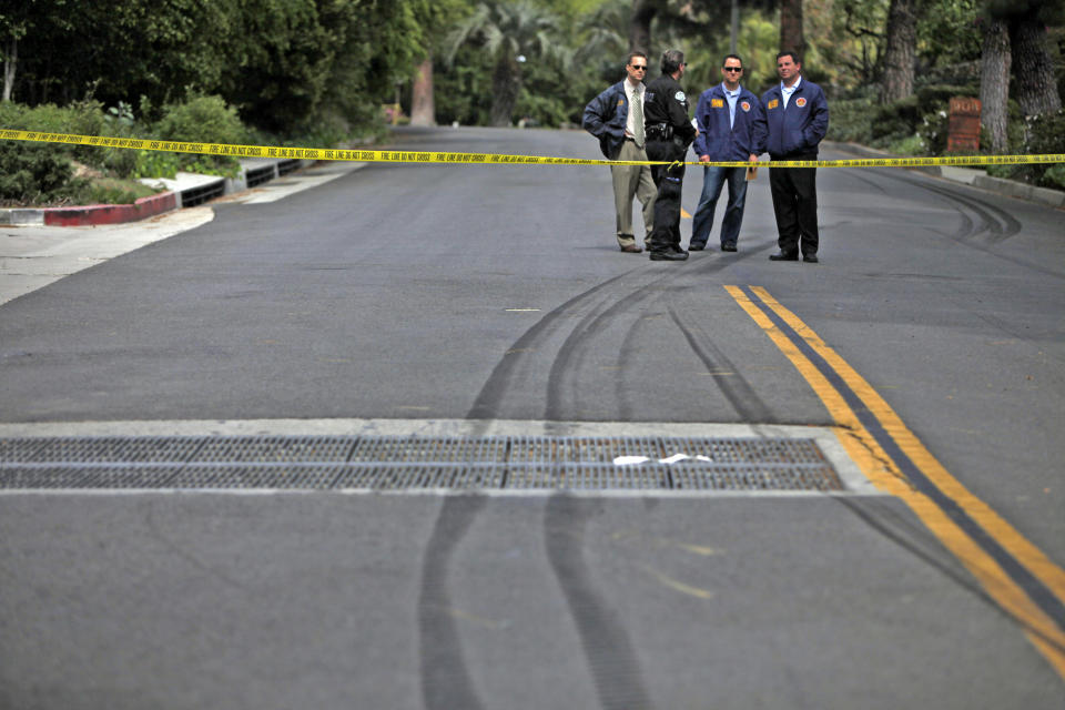 Police investigate the scene of a fatal police car accident, Friday, March 7, 2014 in Beverly Hills, Calif. A veteran Los Angeles police officer was killed and his rookie partner was critically injured Friday when their patrol car collided with a big rig on a residential street. The truck driver also was injured. (AP Photo/Los Angeles Times, Francine Orr, Pool)