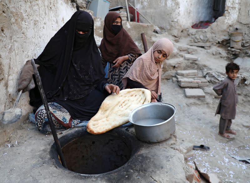 Delkhah Sultani, 30, an Afghan widow who lost her husband in a suicide attack almost six years ago, prepares bread at the oven, amid concerns about coronavirus disease (COVID-19) in Kabul