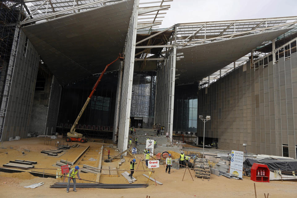 In this Sunday, Dec. 16, 2018 photo, work continues at the Grand Egyptian Museum under construction in Giza, Egypt. Thousands of Egyptians are laboring in the shadow of the pyramids to erect a monument worthy of the pharaohs. The Grand Egyptian Museum has been under construction for well over a decade and is intended to show off Egypt’s ancient treasures while attracting tourists to help fund its future development. (AP Photo/Amr Nabil)