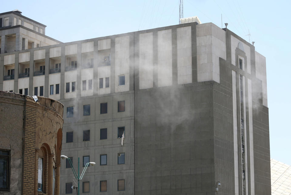 <p>Smoke is seen during an attack on the Iranian parliament in central Tehran, Iran, June 7, 2017. (Photo: Omid Vahabzadeh/TIMA via Reuters) </p>