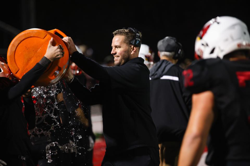 Westwood QB Bobby Guy assists with a Gatorade bath in the closing moments of the team's 20 - 7 win against Rutherford.