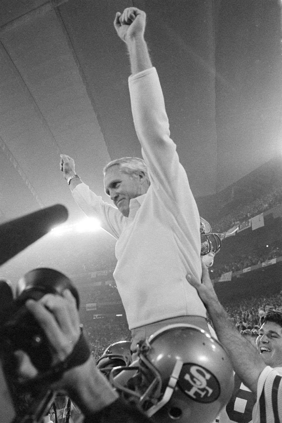 FILE - In this Jan. 25, 1982, file photo, San Francisco 49ers coach Bill Walsh raises his arms in victory as he is carried off the field by his players after their 26-21 Super Bowl XVI win over Cincinnati Bengals in Pontiac, Mich. What doach Kyle Shanahan, quarterback Jimmy Garoppolo, defensive end Nick Bosa and the rest of the San Francisco 49ers are doing this year harkens back to 1981 when Bill Walsh, Joe Montana and Ronnie Lott led the franchise to its first Super Bowl title.(AP Photo/File)