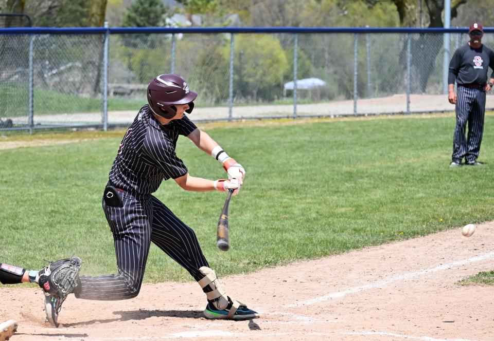 Charlevoix's Owen Waha swings into a pitch during Saturday's matchup against Spring Lake in Petoskey.