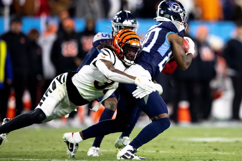 Cincinnati Bengals cornerback Tre Flowers (33) hits Tennessee Titans wide receiver Chester Rogers (80) in the second quarter during an NFL divisional playoff football game, Saturday, Jan. 22, 2022, at Nissan Stadium in Nashville, Tenn. Cincinnati Bengals defeated Tennessee Titans 19-16.