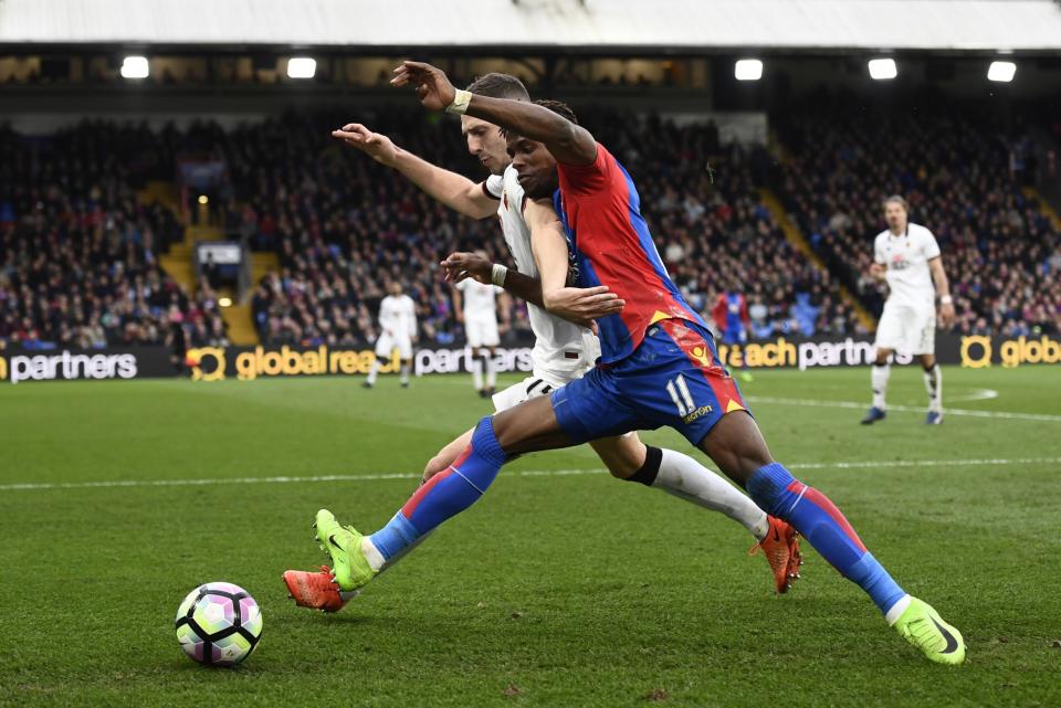 <p>Crystal Palace’s Wilfried Zaha in action with Watford’s Craig Cathcart </p>