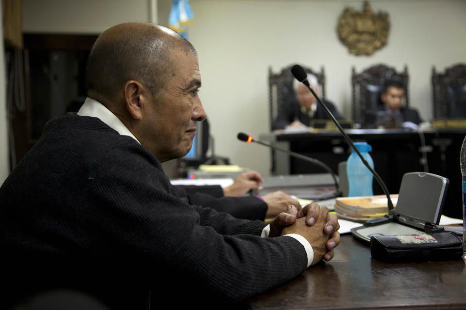 Ex-guerrilla Fermin Felipe Solano Barrillas, who is charged with taking part in a 1988 massacre of more than 20 men, listens to testimony during the El Aguacate Massacre trial in Chimaltenango, Guatemala, Thursday, March 13, 2014. In November 1988 in the mountainous area of western Guatemala, 22 men who lived in the village of El Aguacate where massacred by leftists guerillas during the Guatemalan civil war. The trial that began Thursday, is the first against an ex-guerrilla, who is charged with taking part in the massacre. (AP Photo/Moises Castillo)