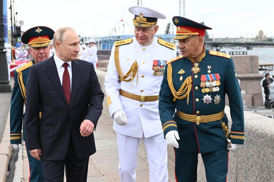 Russian President Vladimir Putin, left, Admiral Nikolai Yevmenov, Commander-in-Chief of the Russian Navy, center, and Russian Defense Minister Sergei Shoigu, right, leave the Navy Day parade in St. Petersburg, Russia, Sunday, July 25, 2021. (Alexei Nikolsky, Sputnik, Kremlin Pool Photo via AP)