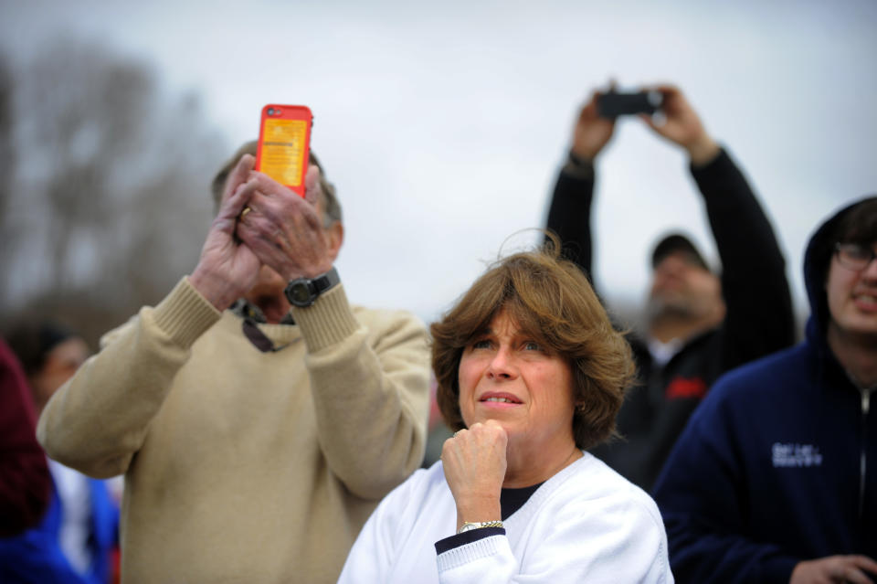 Visitor June Kramarczyk, center, and her husband John Kramarczyk, left, of Bluffton, S.C. watch firefighters battle a blaze in a warehouse at the Georgia Ports Authority Ocean Terminal in Savannah, Ga. on Saturday, Feb. 8, 2014. A Georgia Ports Authority spokesman said all port workers were safe and accounted for after the fire broke out. (AP Photo/Stephen B. Morton)