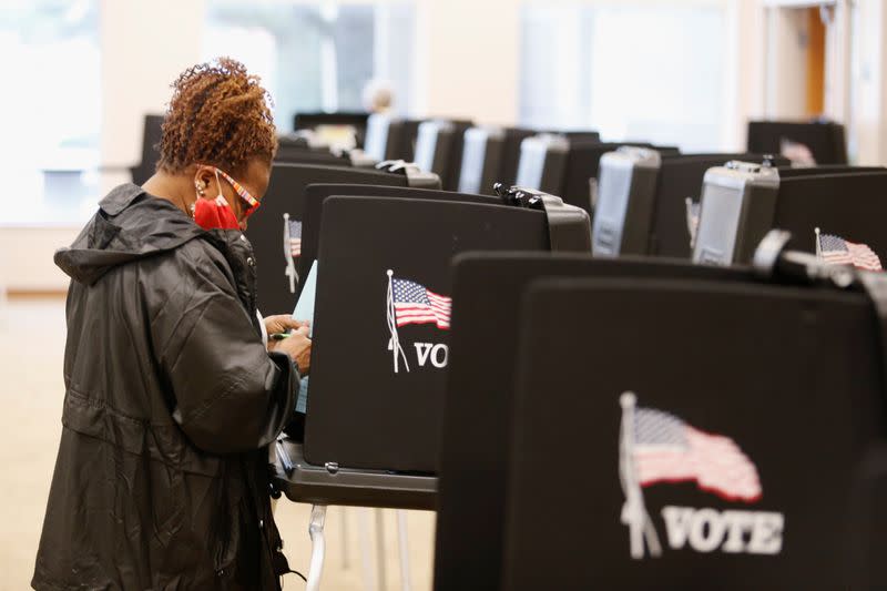 Voters line up to cast their ballots for the presidential primary elections in Columbus