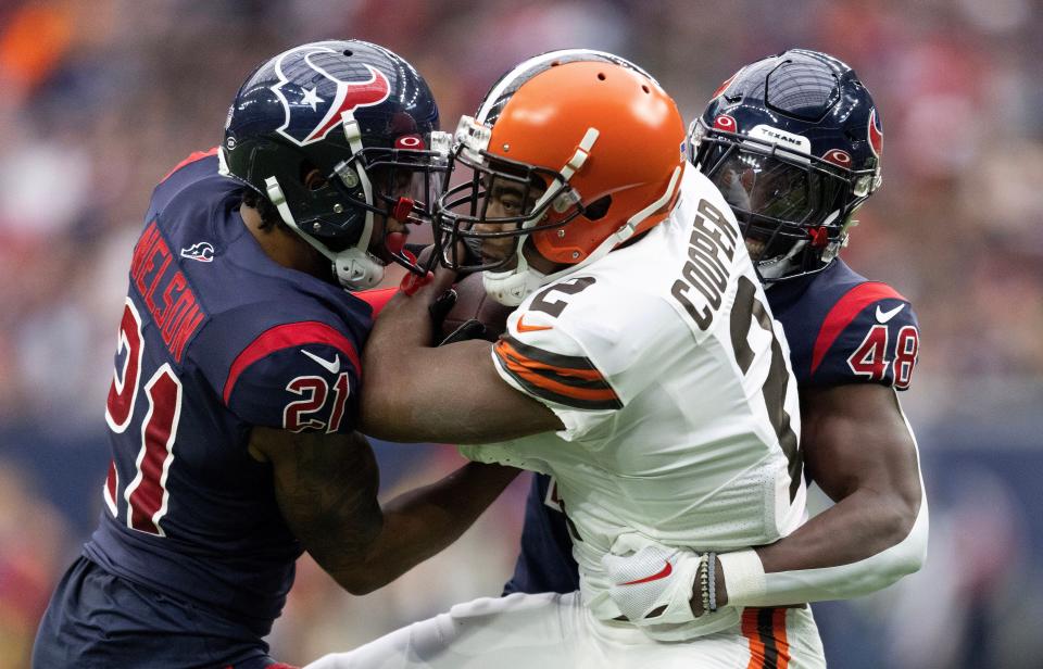 Cleveland Browns wide receiver Amari Cooper (2) is tackled by Houston Texans cornerback Steven Nelson (21) and linebacker Christian Harris (48) in the second quarter at NRG Stadium.