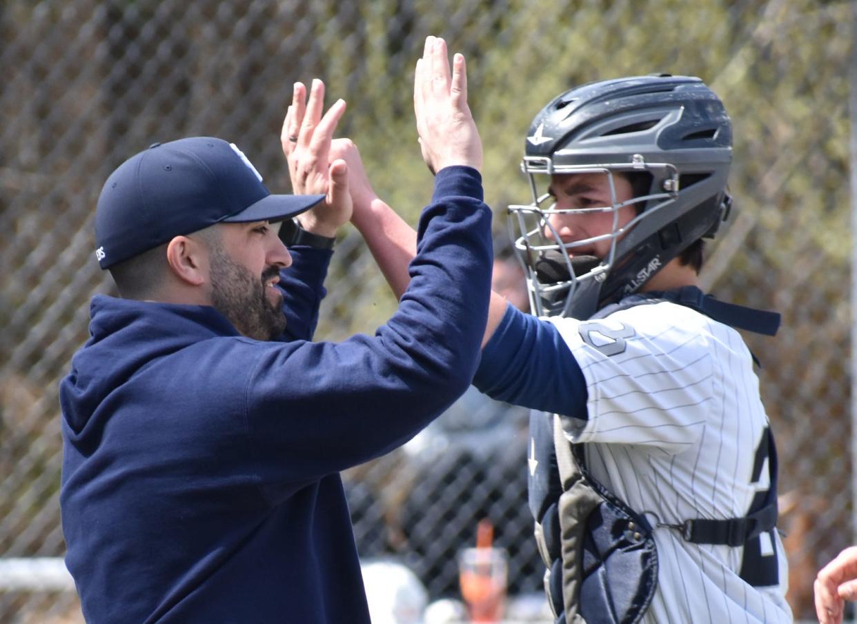 Somerset Berkley head baseball coach Jason Martin and catcher Liam Meehan celebrate an out during a recent game in Berkley.