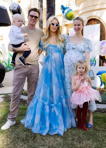 <p>Kevin Ostajewski</p> Barron Hilton and son Caspian, Paris Hilton, Tessa Hilton and daughter Milou