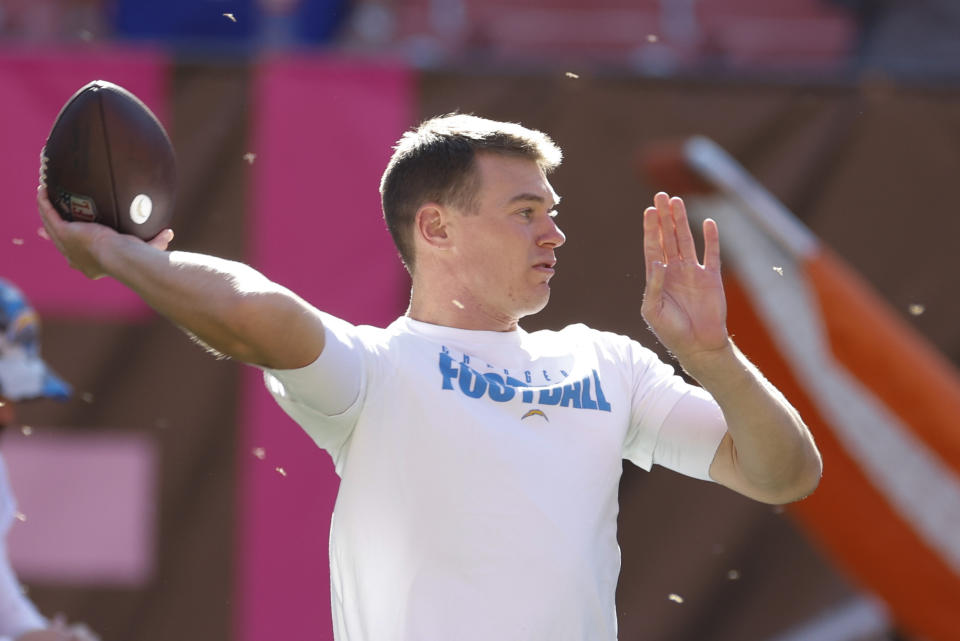 Los Angeles Chargers quarterback Easton Stick (2) throws a pass with a swarm of flying insects around him as he warms up before an NFL football game against the Cleveland Browns, Sunday, Oct. 9, 2022, in Cleveland. (AP Photo/Ron Schwane)