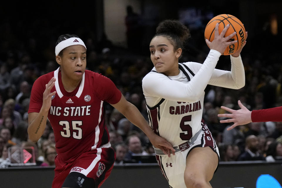 South Carolina guard Tessa Johnson (5) drives past North Carolina State guard Zoe Brooks (35) during the second half of a Final Four college basketball game in the women's NCAA Tournament, Friday, April 5, 2024, in Cleveland. South Carolina won 78-59. (AP Photo/Carolyn Kaster)