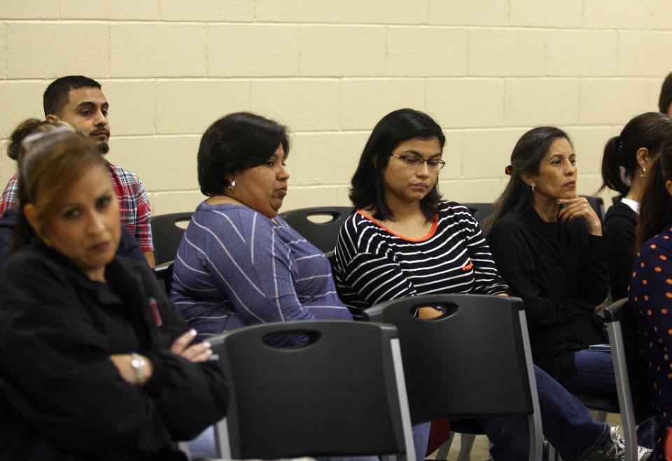 In a Saturday, Jan. 11, 2014 photo, people listen to La Villa Mayor Hector Elizondo talk with La Villa Independent School District Superintendent Narciso Garcia over a speaker phone about the city turning the water supply to the school district back on during a special meeting at La Villa City Hall in La Villa, Texas. The City of La Villa turned off the school districts water at their four campuses over the winter break after the water bill went unpaid. Classes that were to resume on Monday have been canceled until Wednesday as the water rate is negotiated. (AP Photo/Joel Martinez/The Monitor)