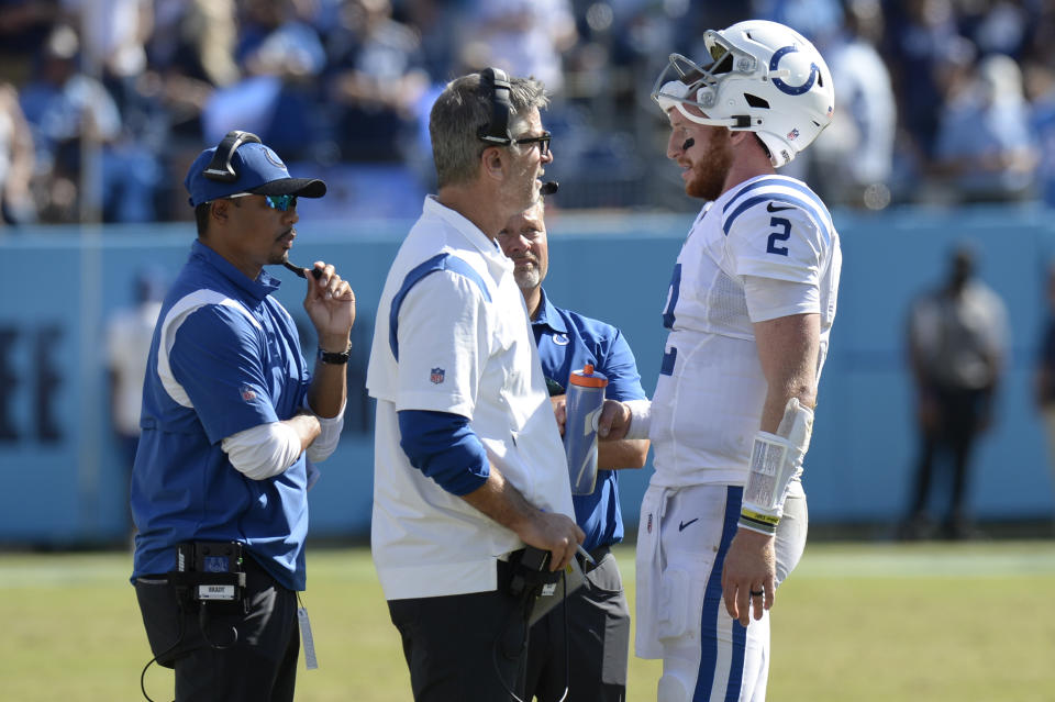 Indianapolis Colts quarterback Carson Wentz (2) talks with head coach Frank Reich and offensive coordinator Marcus Brady, left, in the second half of an NFL football game against the Tennessee Titans Sunday, Sept. 26, 2021, in Nashville, Tenn. (AP Photo/Mark Zaleski)