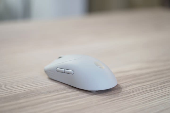 The Alienware Pro Wireless Mouse on a wooden table.