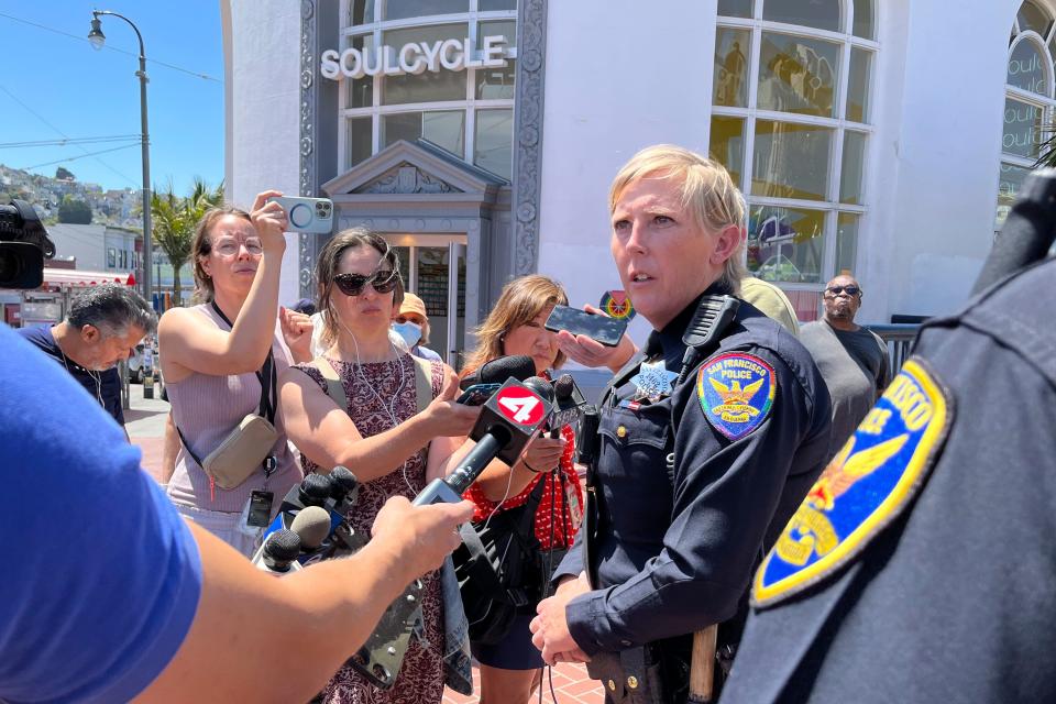 San Francisco Police Officer spokesperson Kathryn Winters speaks with reporters outside the entrance to the Castro Muni station following a shooting in San Francisco, Wednesday, June 22, 2022. (AP Photo/Janie Har)