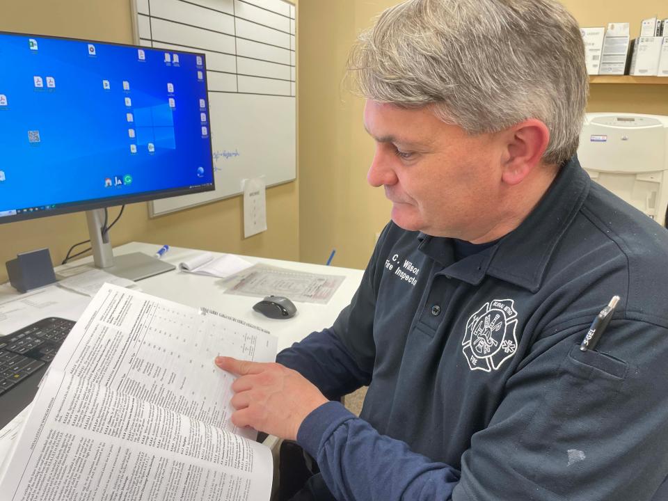 New Town of Farragut Fire Inspector Charles Wilson examines building plans for a sprinkler review in his office Tuesday, Feb. 14, 2023.