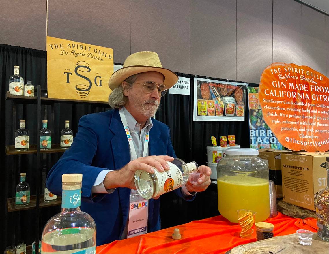 Miller Duvall, president of The Spirit Guild, prepares samples of gin and vodka made with citrus fruit. The Los Angeles distillery, which is looking to move to the Fresno area, was at the MADE Central California show. Bethany Clough/bclough@fresnobee.com