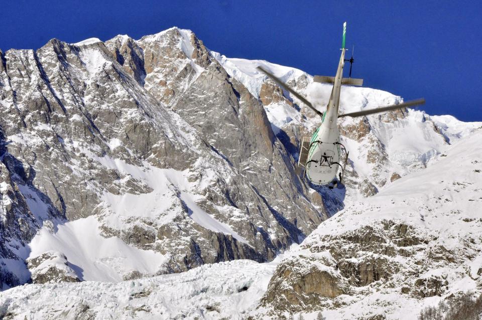 An helicopter of the Valdostano Alpine Rescue corp leaves an helipad in Aosta, Italy, Monday, Feb. 4, 2019, to reach the spot where the bodies of three skiers where found. Rescuers have found the bodies of three skiers in Italy's Alps and are searching for a fourth, raising the death toll in recent avalanches in the country to at least five. The Valdostano Alpine Rescue aircraft on Monday, searching for two British and two French skiers who were reported missing a day earlier, spotted three bodies. Dogs were helping in the search. (Thierry Pronesti/ANSA Via AP)