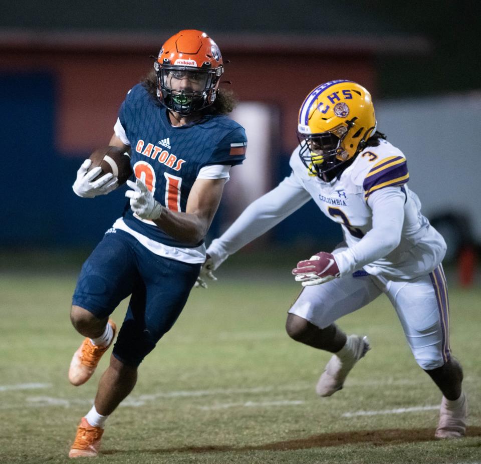 Dorrion Brooks (21) carries the ball during the Columbia vs Escambia FHSAA Class 3S state tournament playoff football game at Escambia High School in Pensacola on Friday, Nov. 18, 2022.